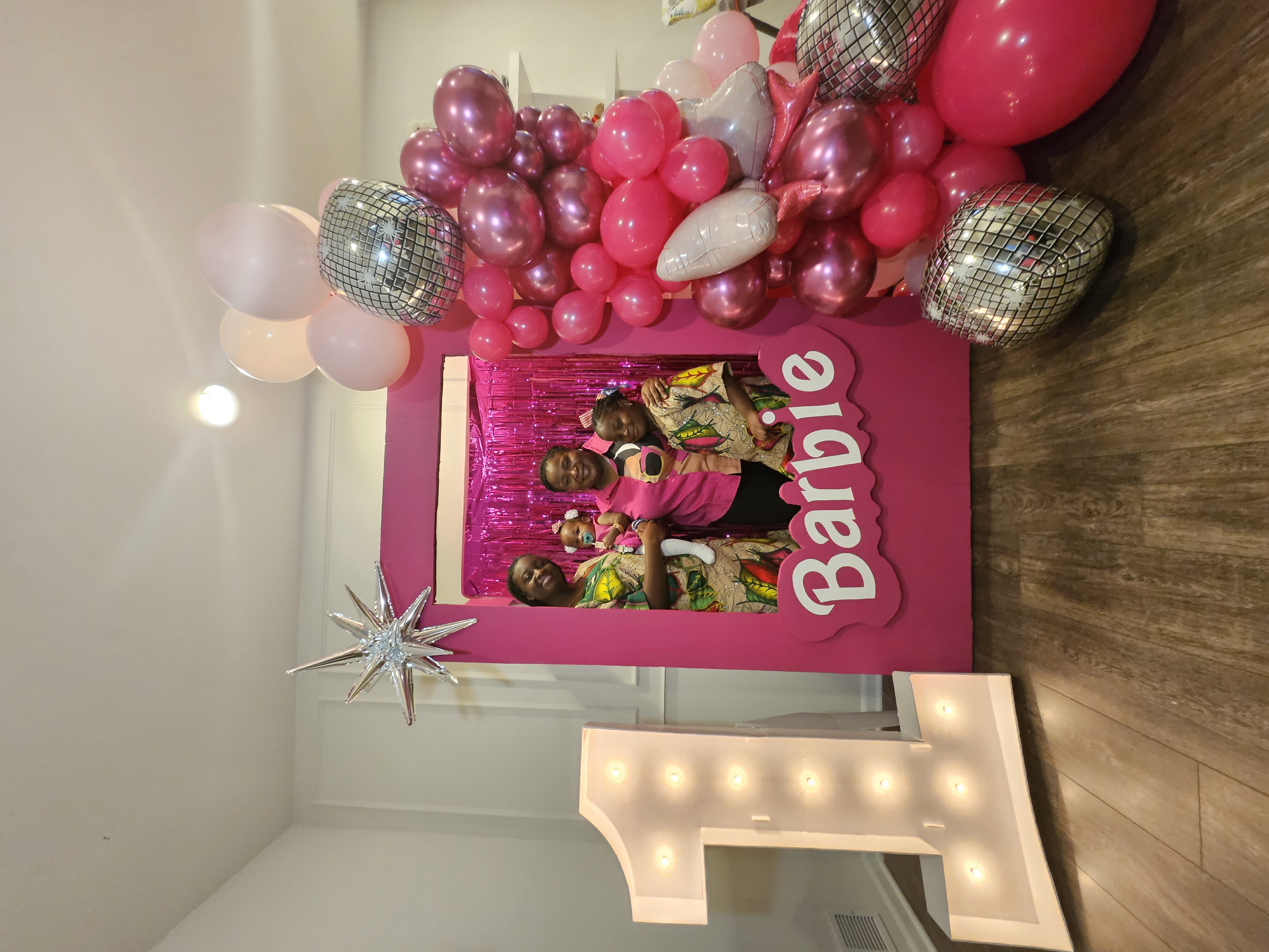 Barbie themed photo booth with disco ball balloons