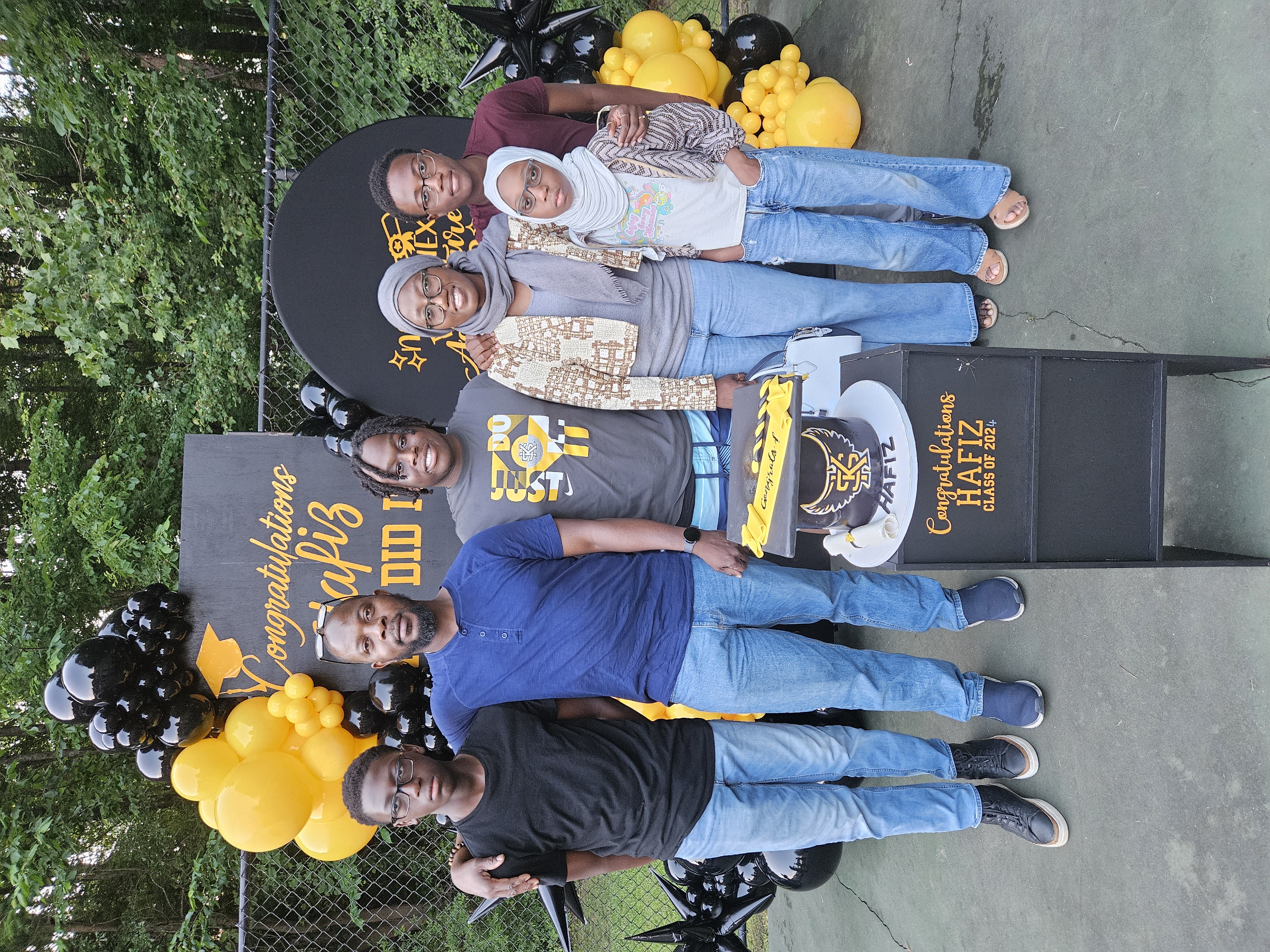 Graduation celebration with black and gold balloon arrangements