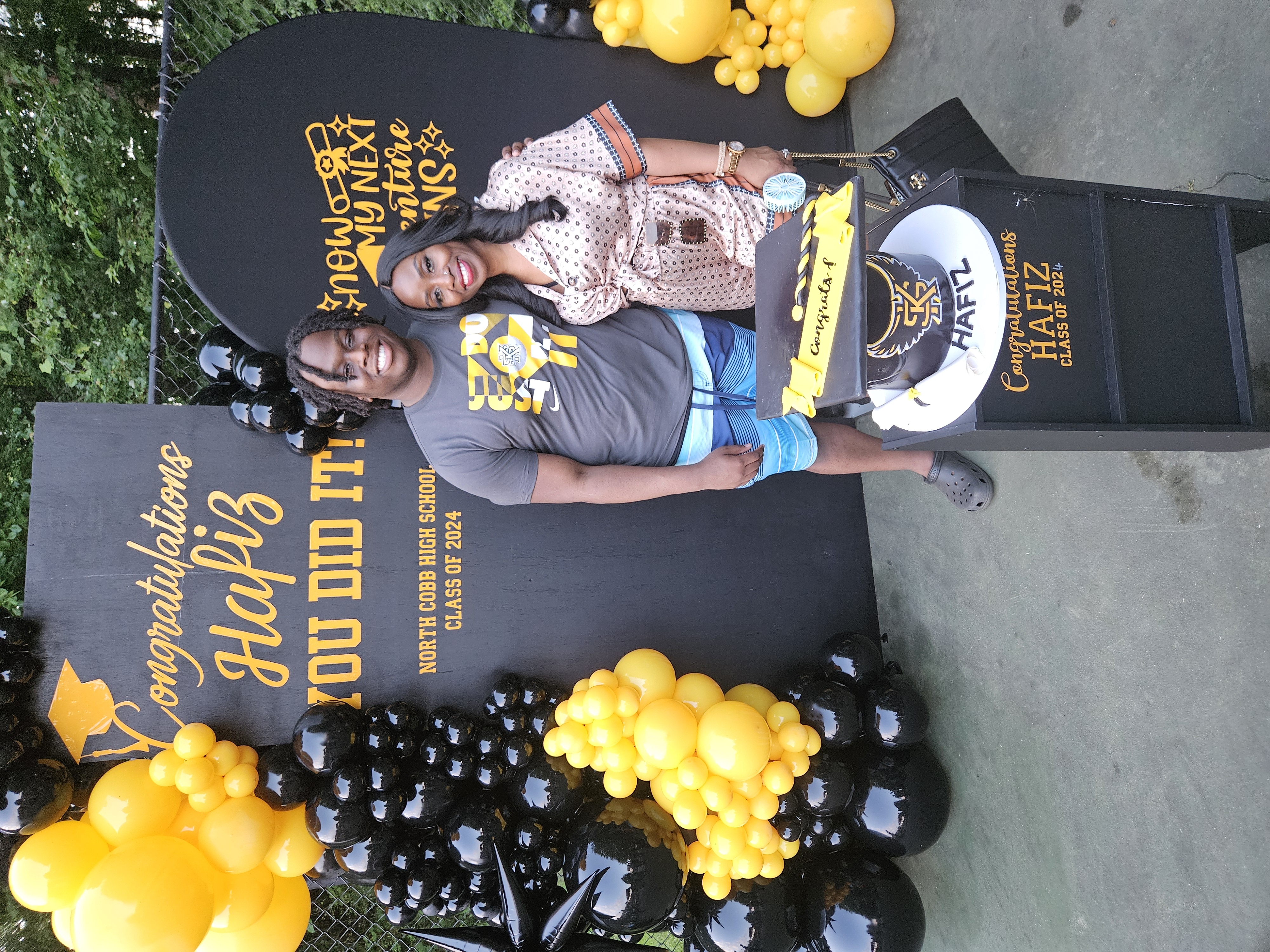Black and yellow graduation themed balloon display